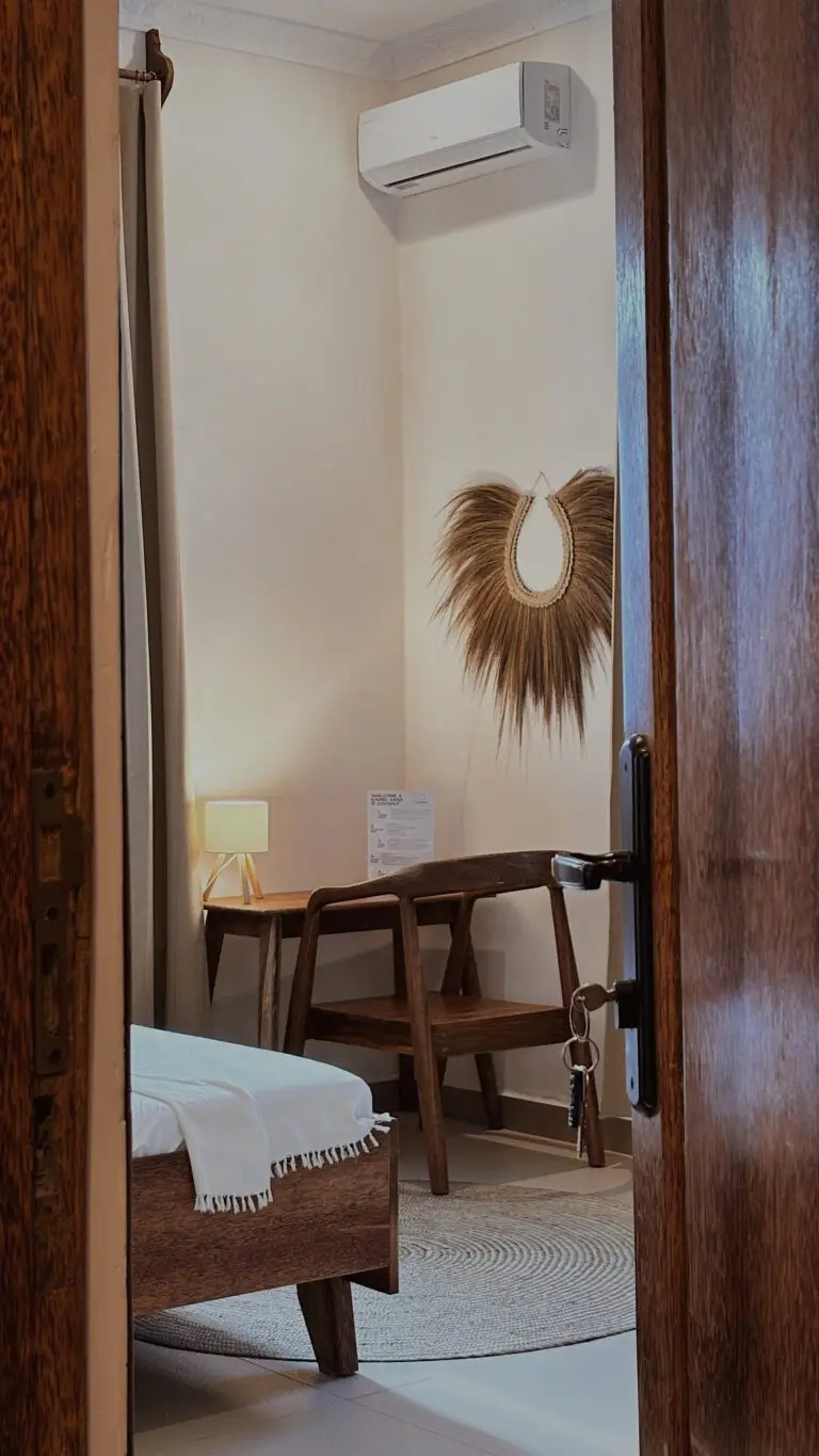 View through the open door to a desk and chair in a guest room