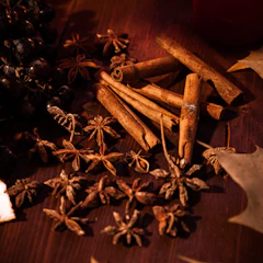 Cinnamon, cloves and star anise on wood